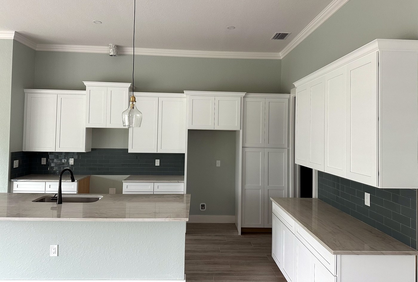 Deep green subway tile backsplash with white grout