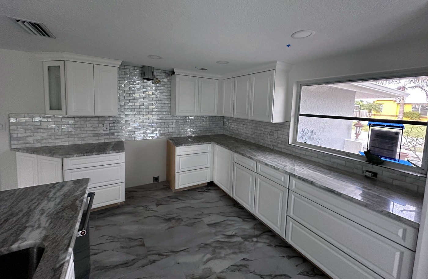 Iridescent glass subway tile full-height backsplash