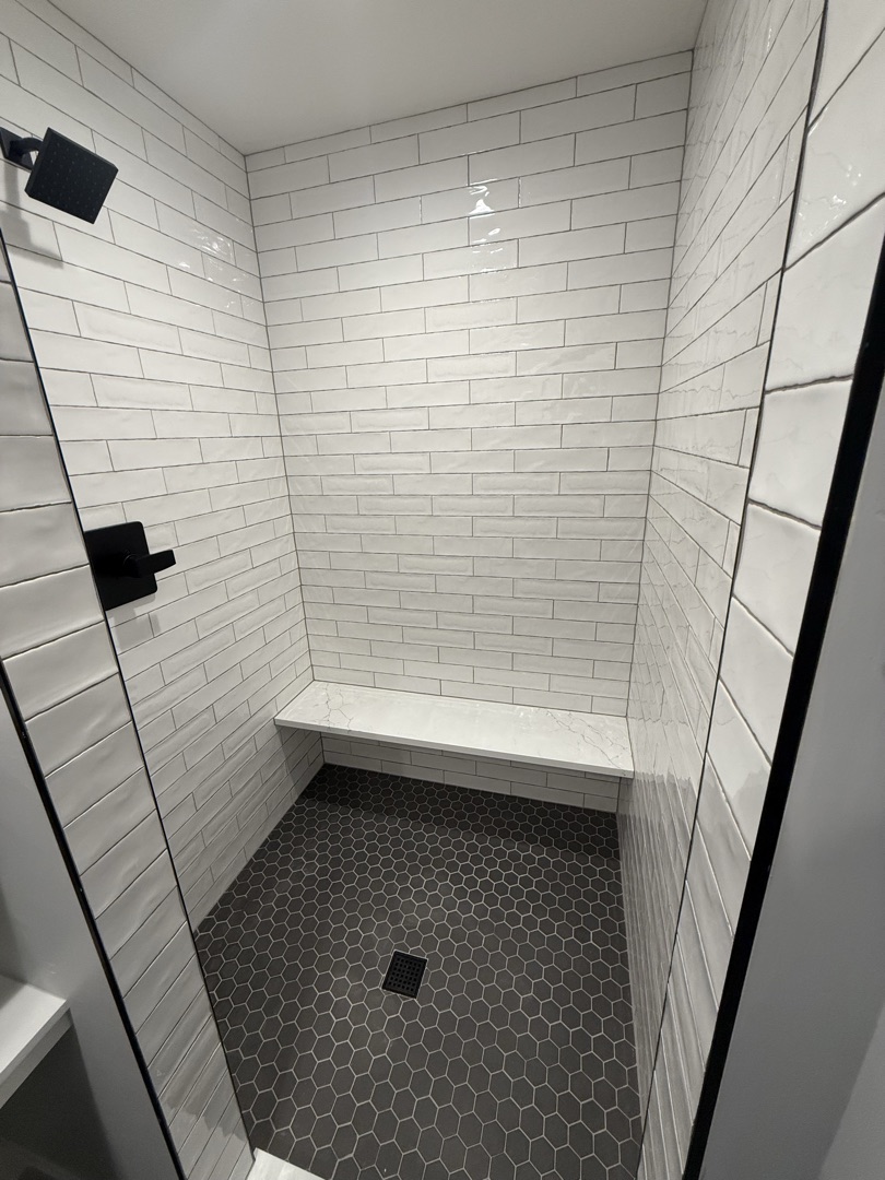 White subway tile bathtub surround with corner shelves