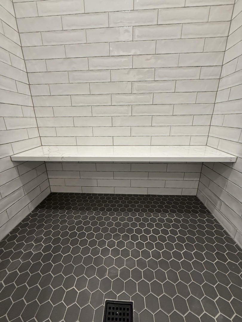 Shower bench detail with hexagon floor tiles