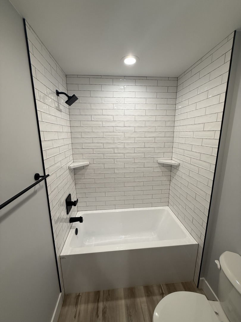 White subway tile shower with hexagon floor