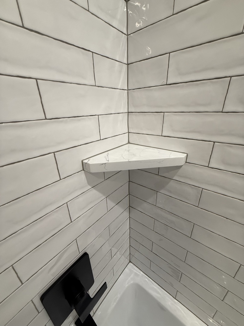 White subway tile corner shelf detail