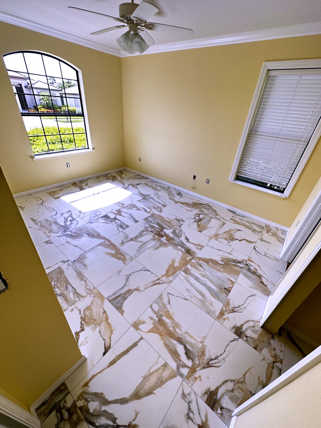 White marble-look floor tile with gold veining