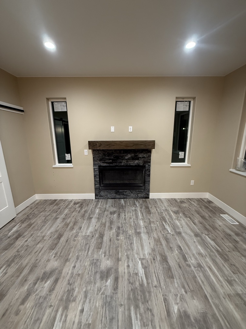 Stone fireplace surround with wood mantel