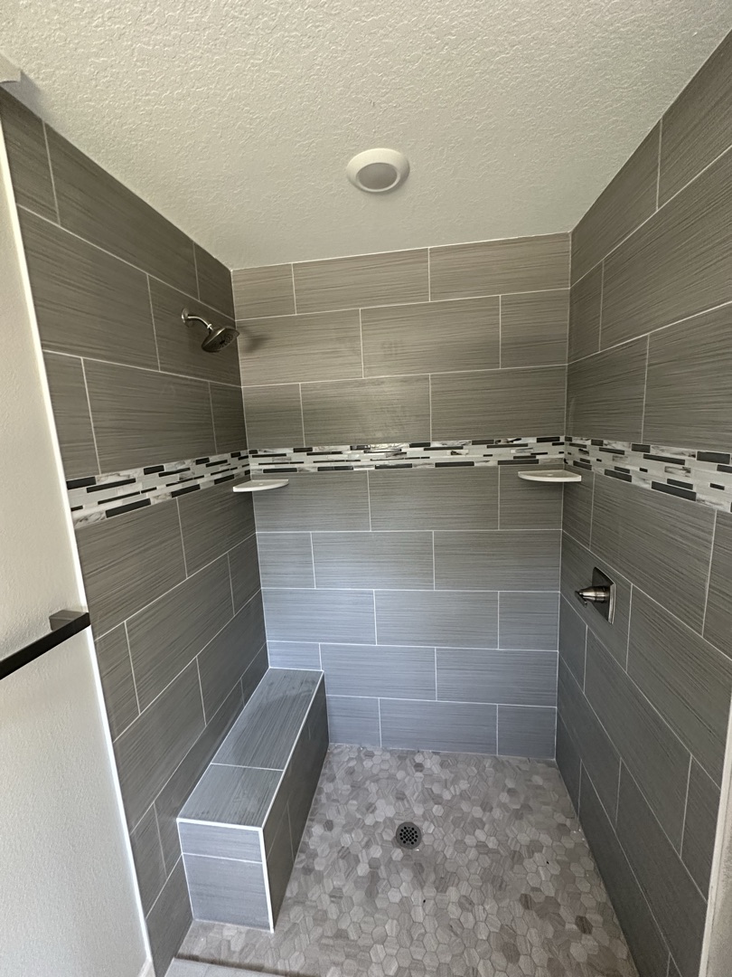 Navy blue subway tile bathtub surround